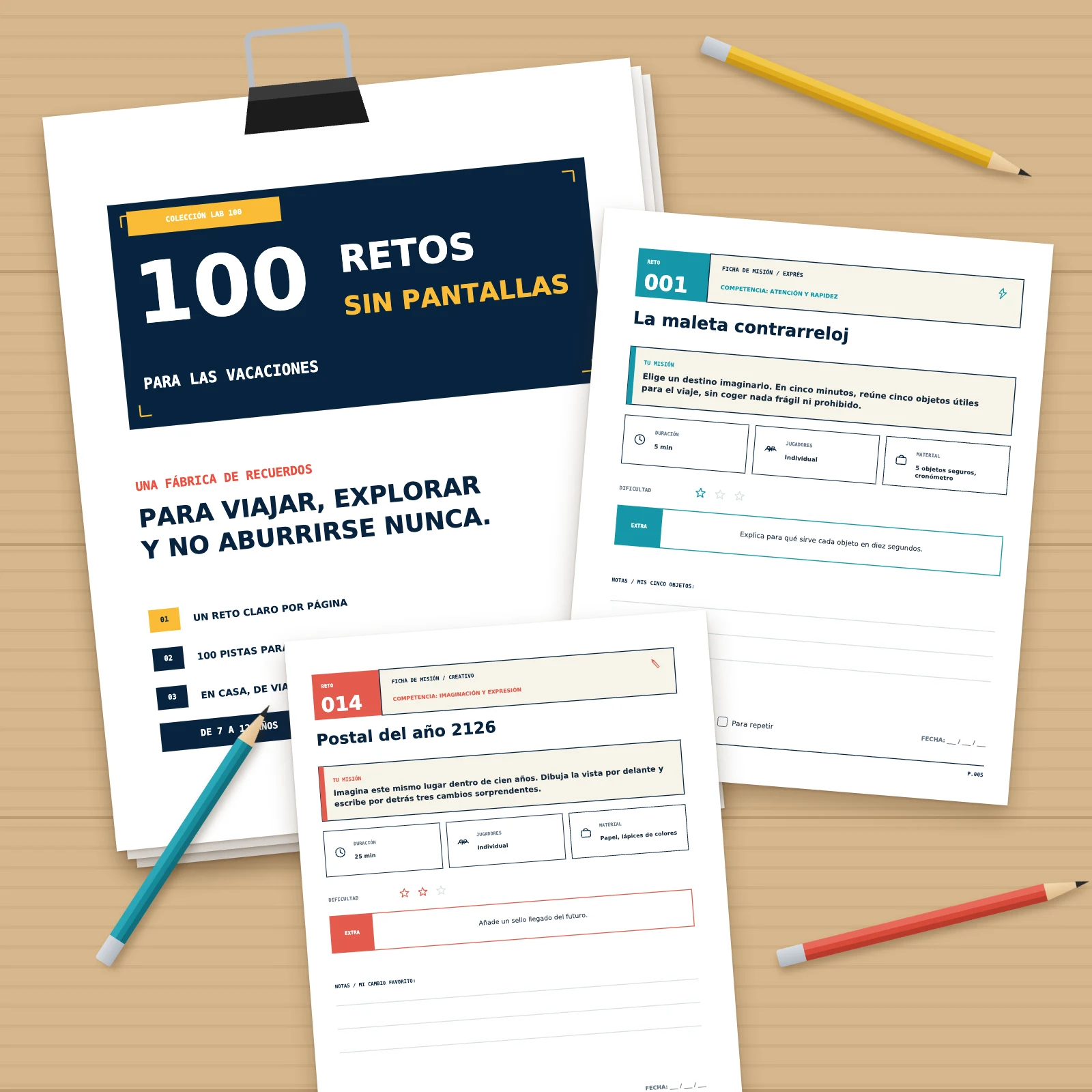 Páginas impresas del PDF sobre una mesa de madera: portadilla sobre una pila sujeta con una pinza, retos 001 y 014, lápices de colores