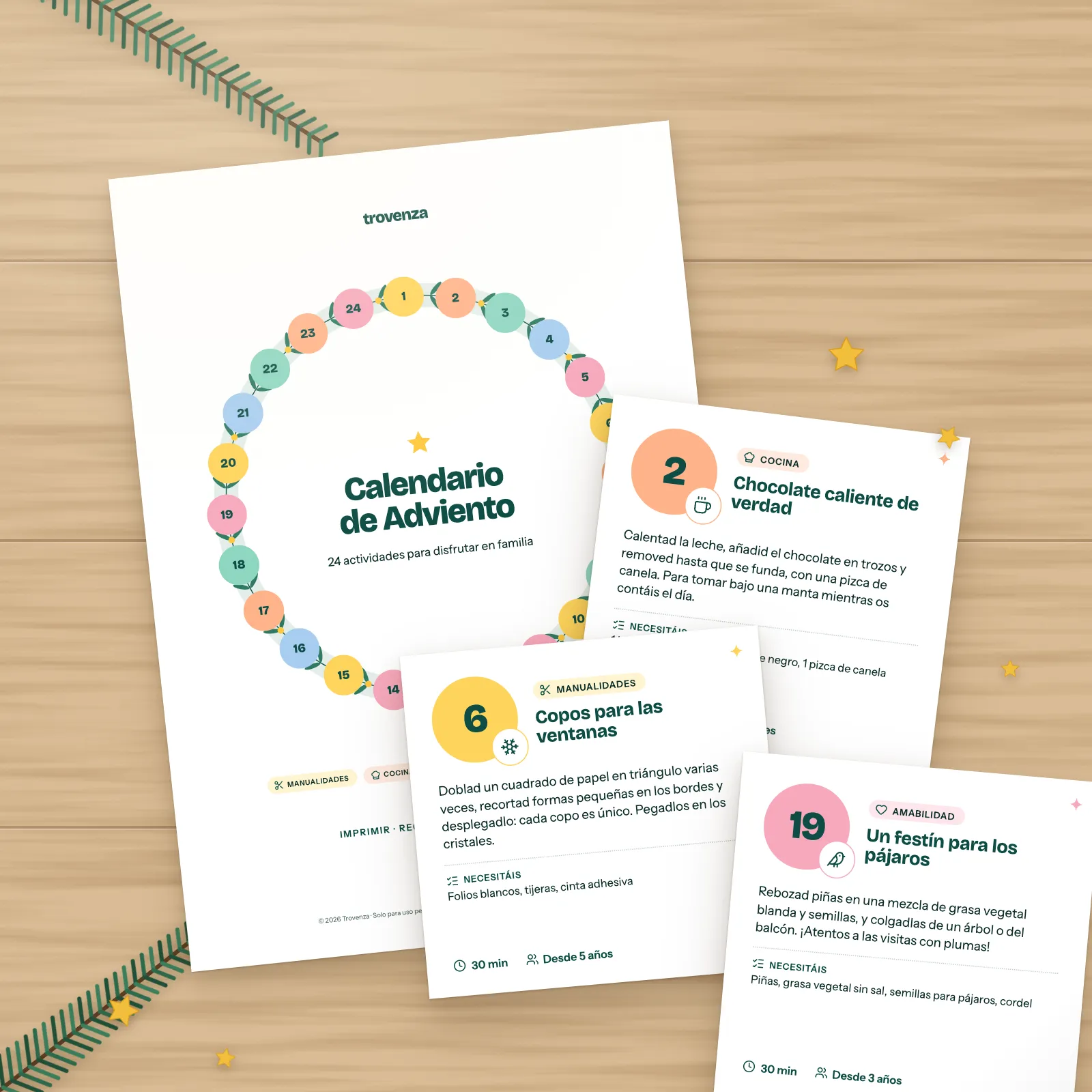 Portada y tarjetas de actividades del calendario de Adviento imprimible sobre una mesa de madera