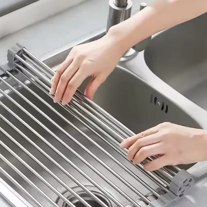 Hands unrolling the rack over the sink