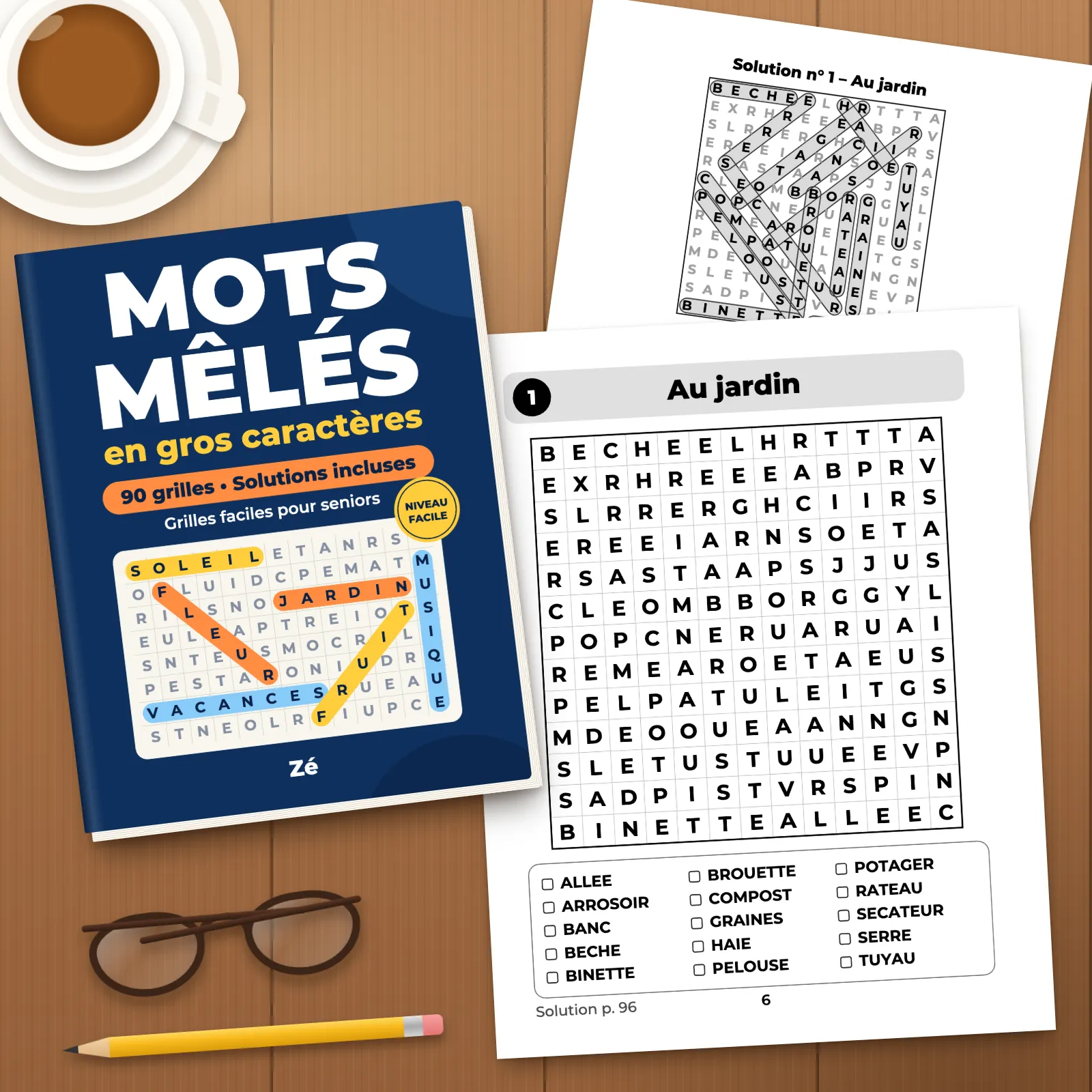 Le livre posé sur une table en bois, avec deux pages imprimées (la grille 1 « Au jardin » et sa solution), une tasse, des lunettes et un crayon